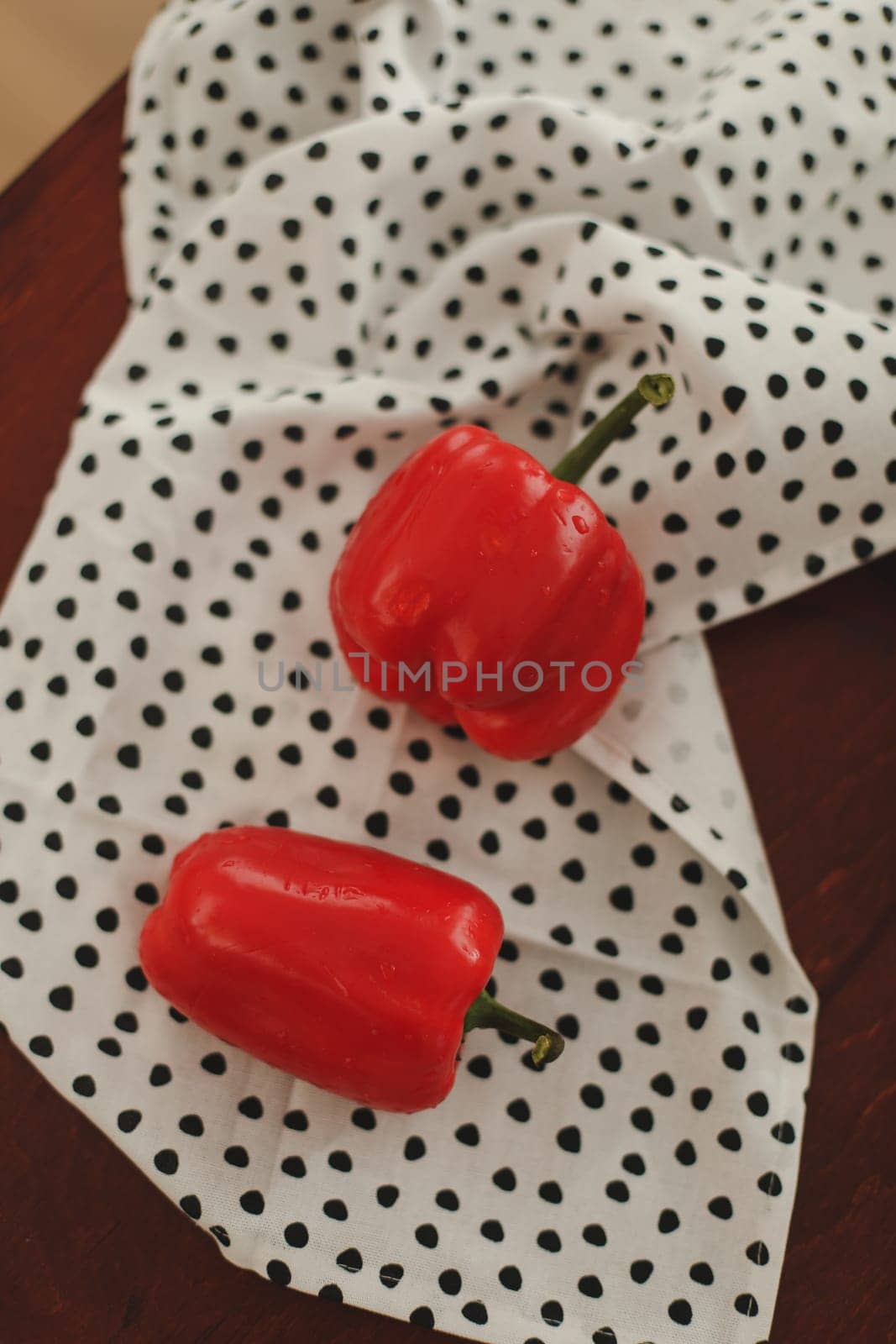 Sweet red peppers on towel on a white table top view