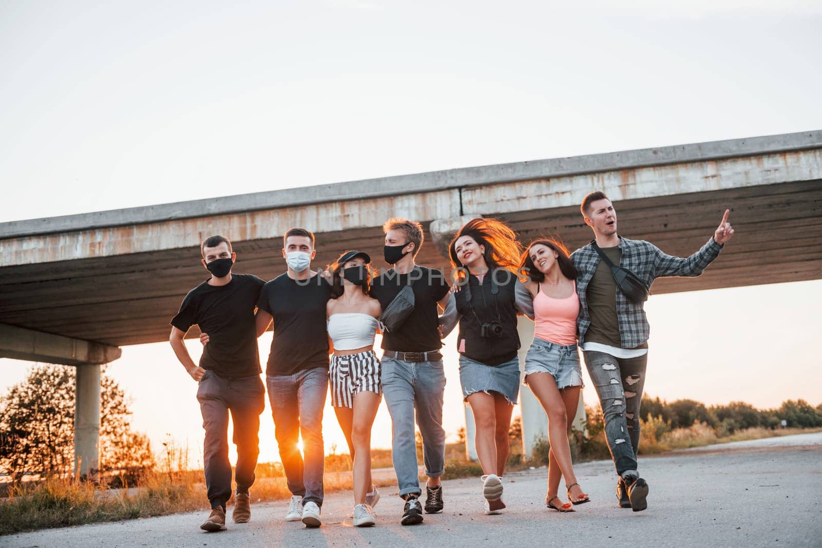 Embracing each other. Group of young cheerful friends having fun together. Party outdoors.