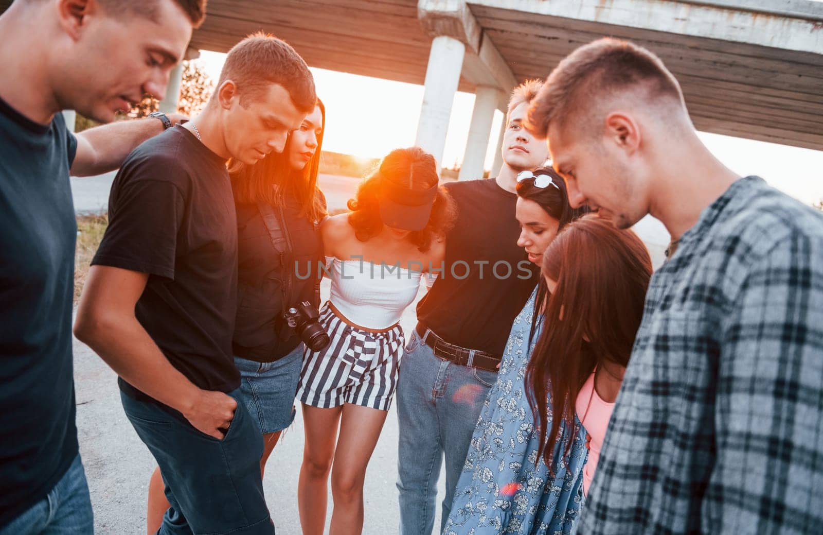 Talking and laughing. Group of young cheerful friends having fun together. Party outdoors.