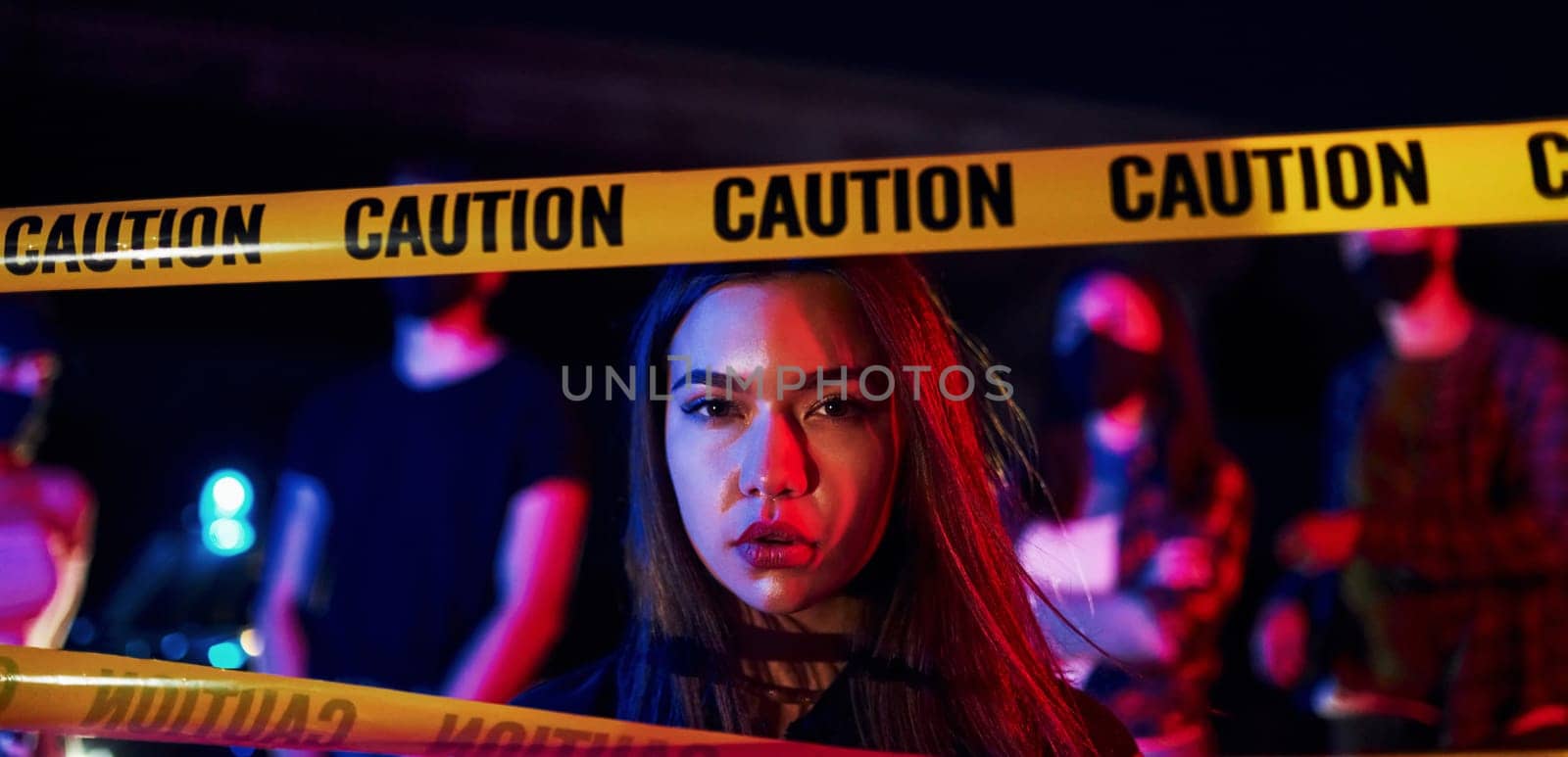 Beautiful woman near police border line. Group of protesting young people that standing together. Activist for human rights or against government by Standret