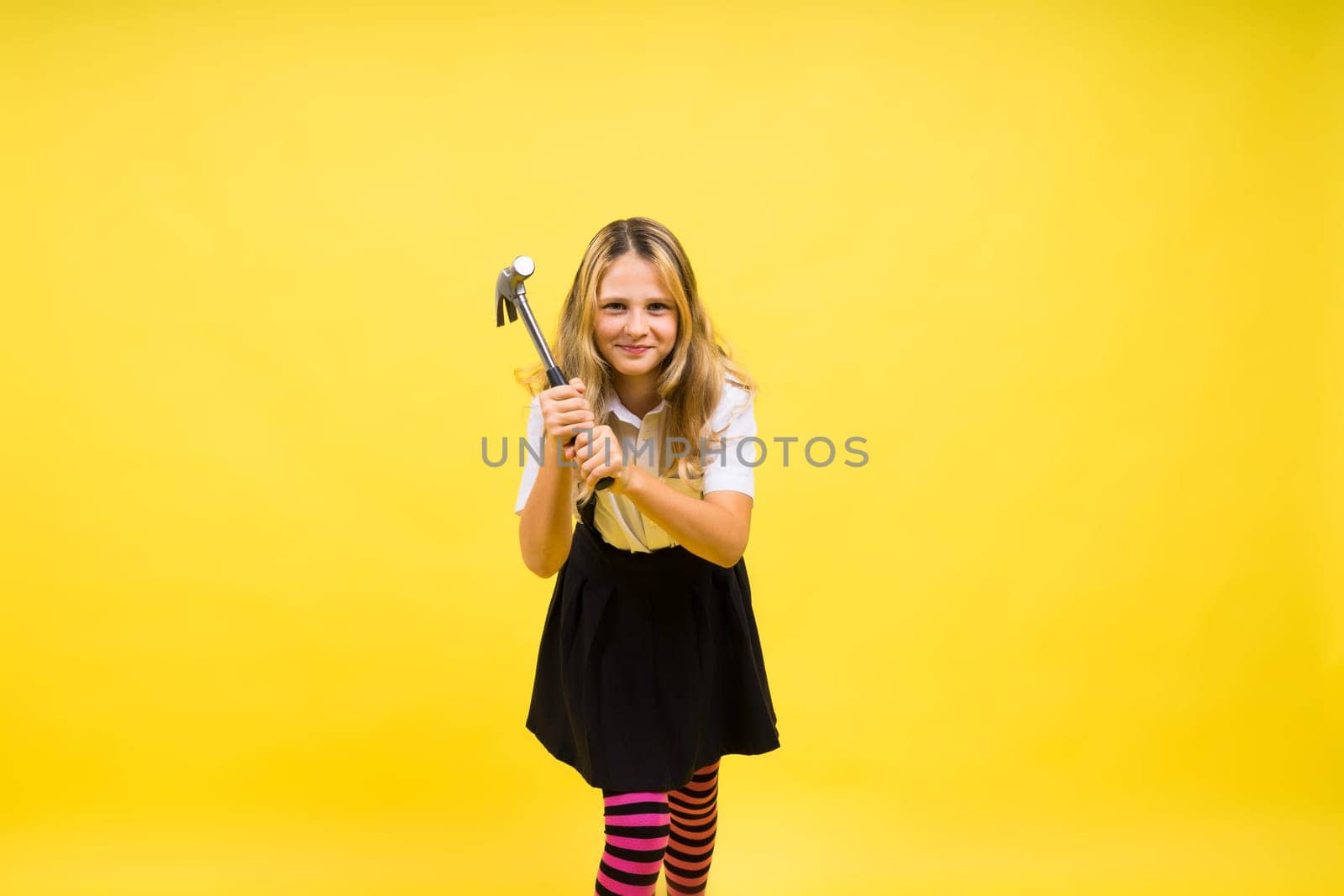 Future engineer. happy kid use hammer repairing tool. building construction site. by Zelenin