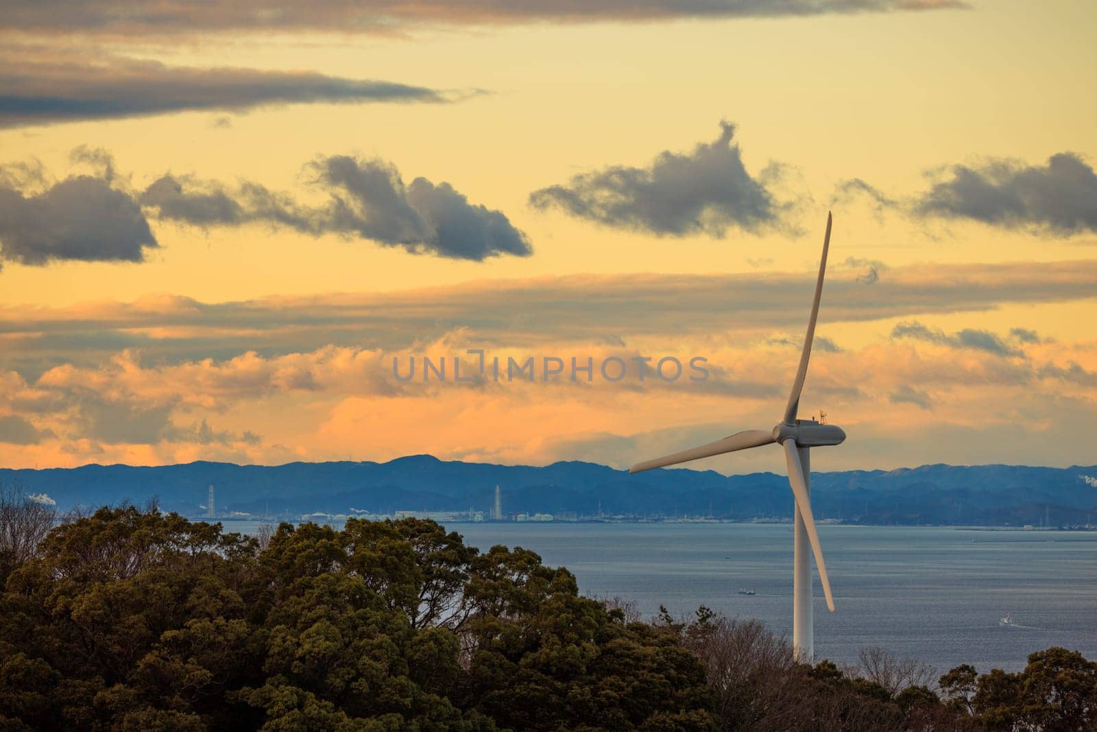 Coastal Wind Turbine with Beautiful Sunset Sky in Background by Osaze