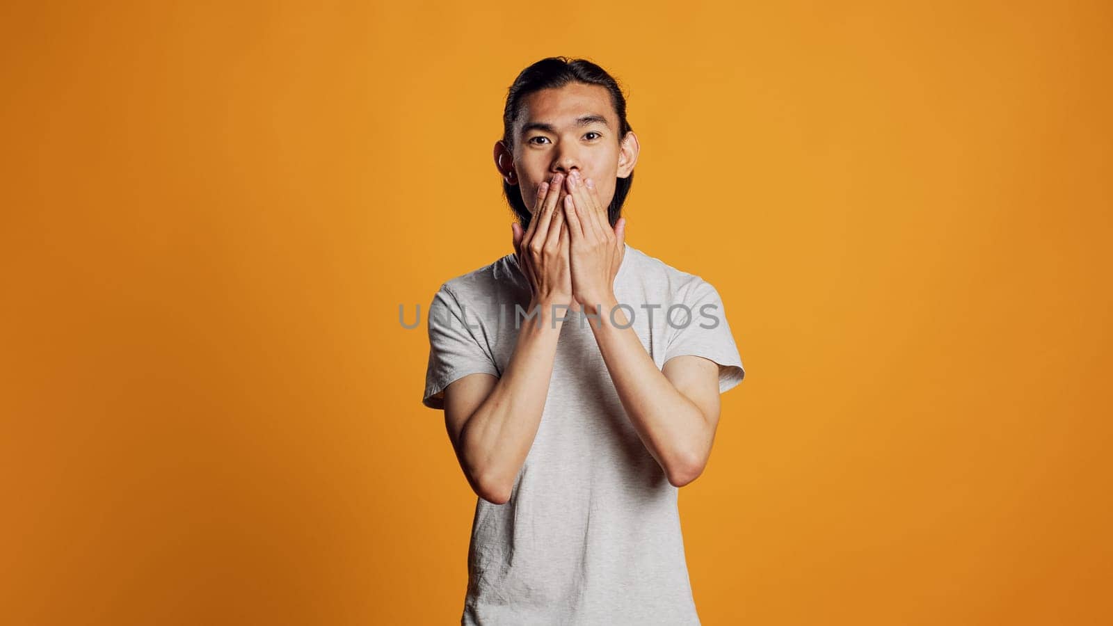 Asian adult sending air kisses on camera by DCStudio