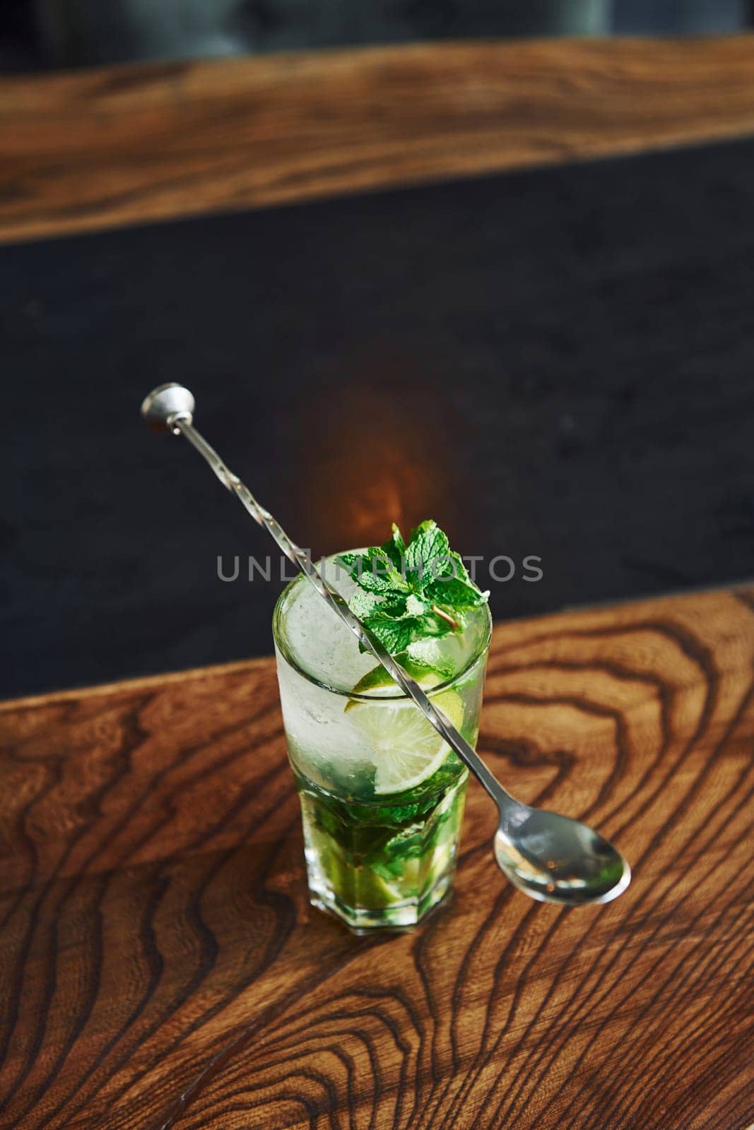 Close up view of fresh summer non alcoholic mojito cocktail on the wooden table.