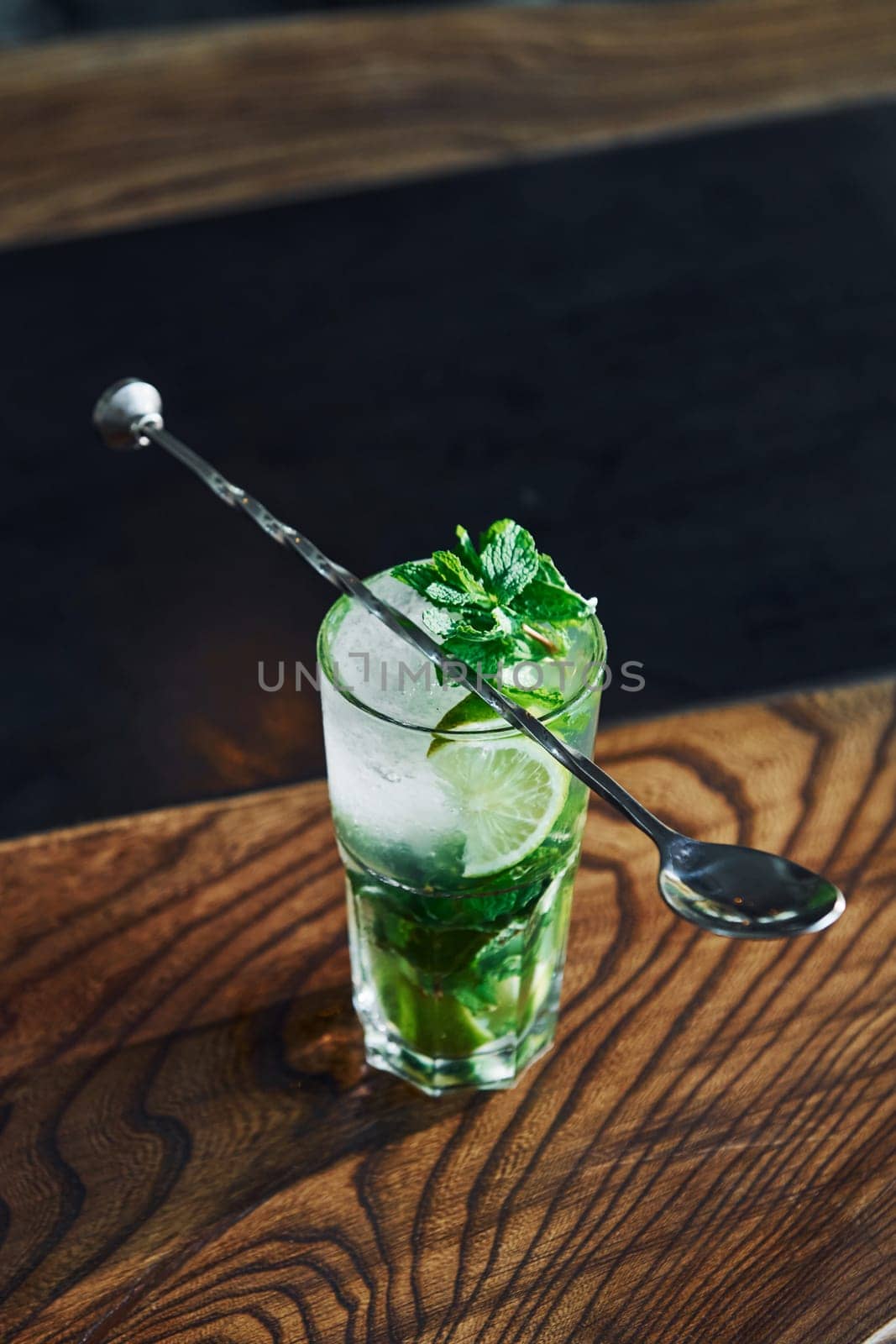 Close up view of fresh summer non alcoholic mojito cocktail on the wooden table.