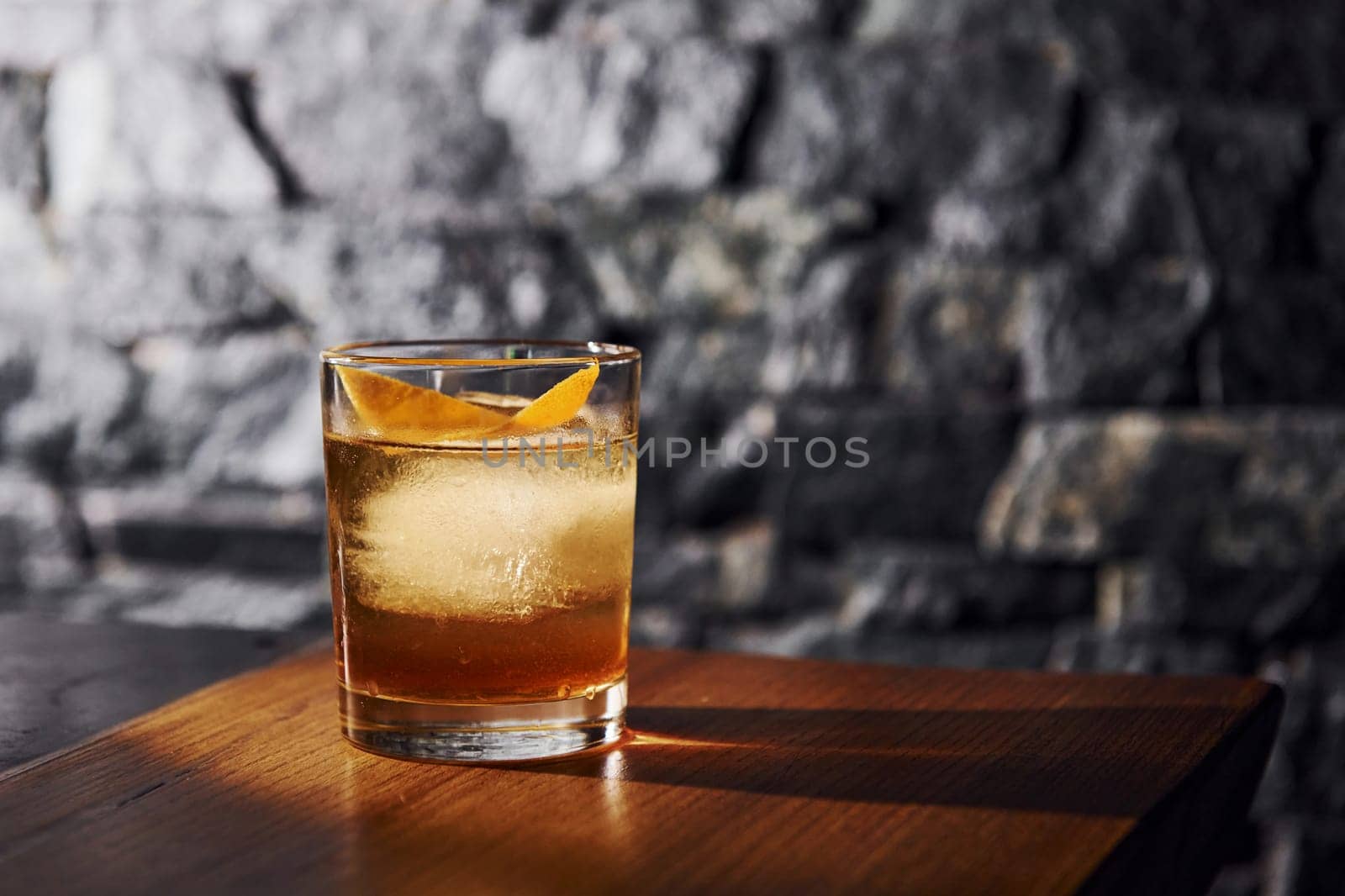 Ice cubes inside. Close up view of fresh summer cocktail on the wooden table.