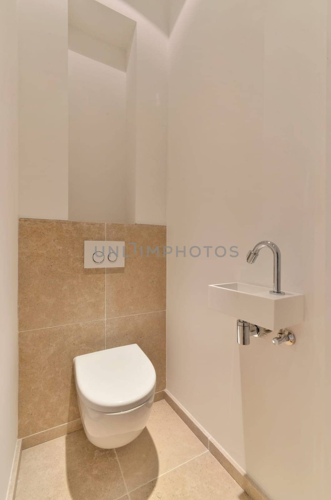 a small bathroom with a toilet and a sink by casamedia