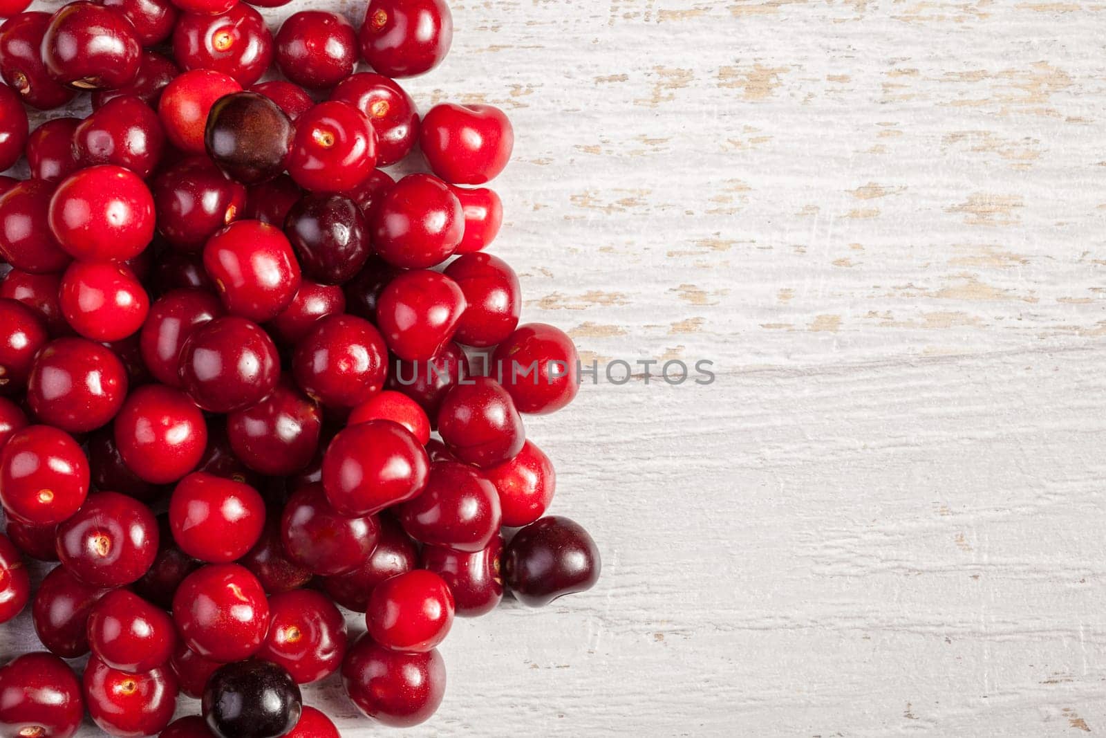 Juicy fresh cherry on wooden background. Vitamin, summer and healthy lifestyle