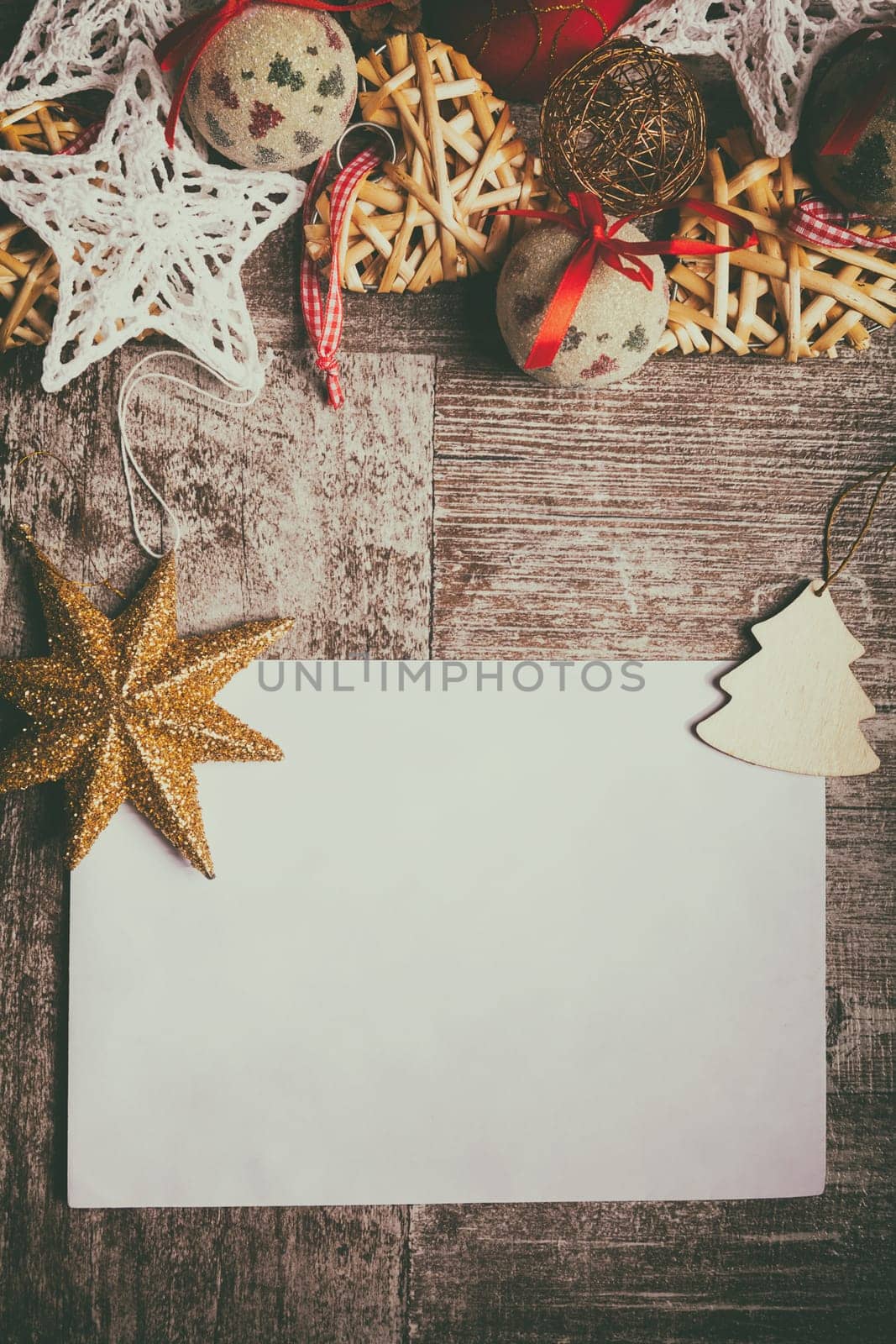 Christmas letter on wooden background with decorations arround. Xmas ornaments