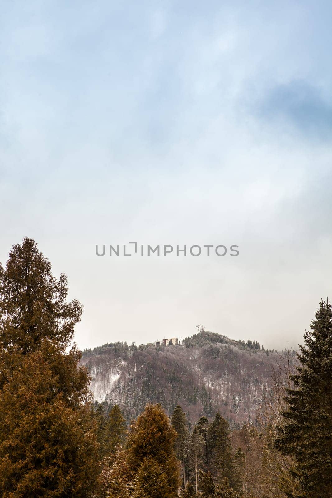 Mountains and clouds in winter by DCStudio
