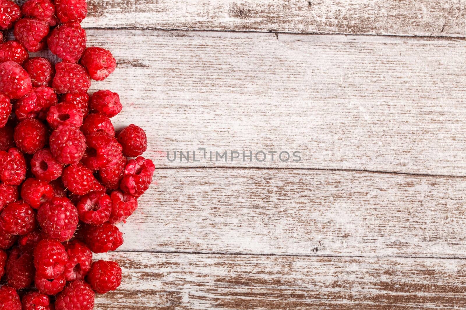 Summer fresh fruits. Raspberry on wooden table by DCStudio
