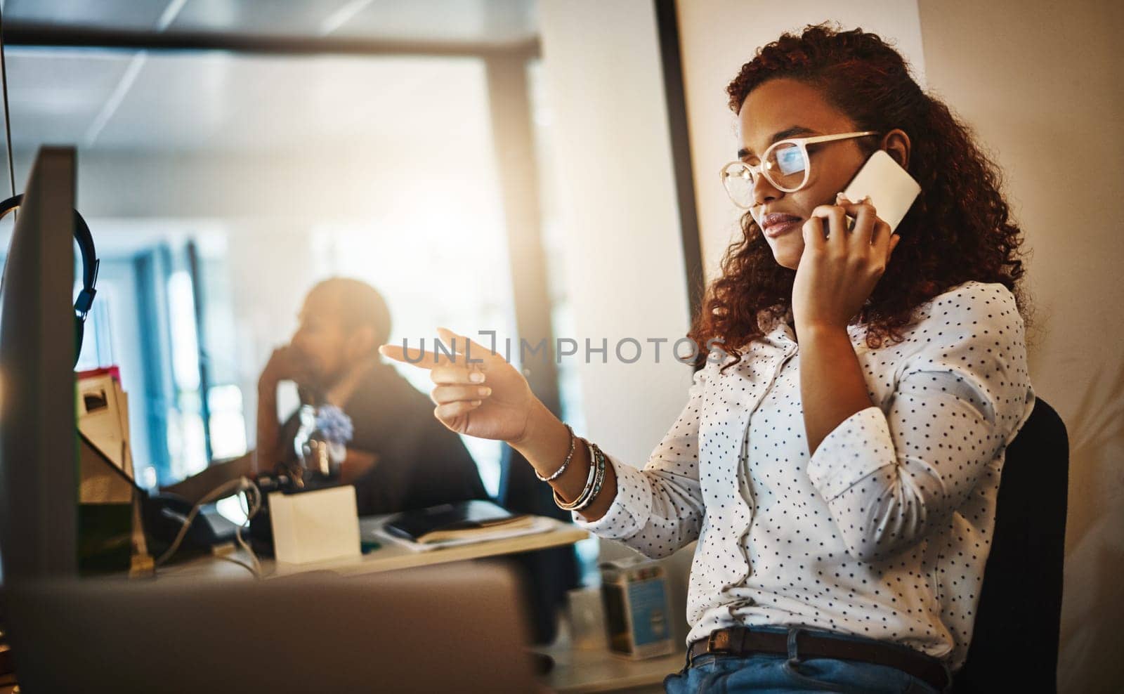 Ill have it done asap. a young businesswoman using a mobile phone and computer during a late night at work. by YuriArcurs