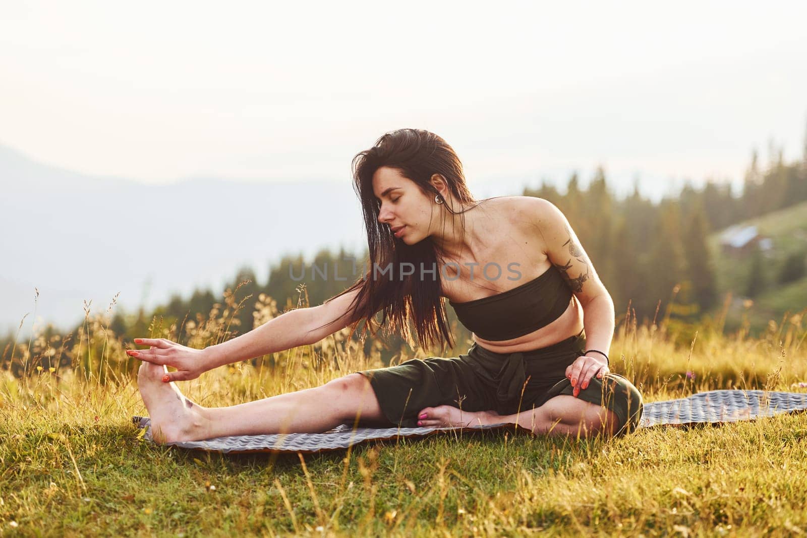 Beautiful young woman doing yoga exercises. Majestic Carpathian Mountains. Beautiful landscape of untouched nature by Standret