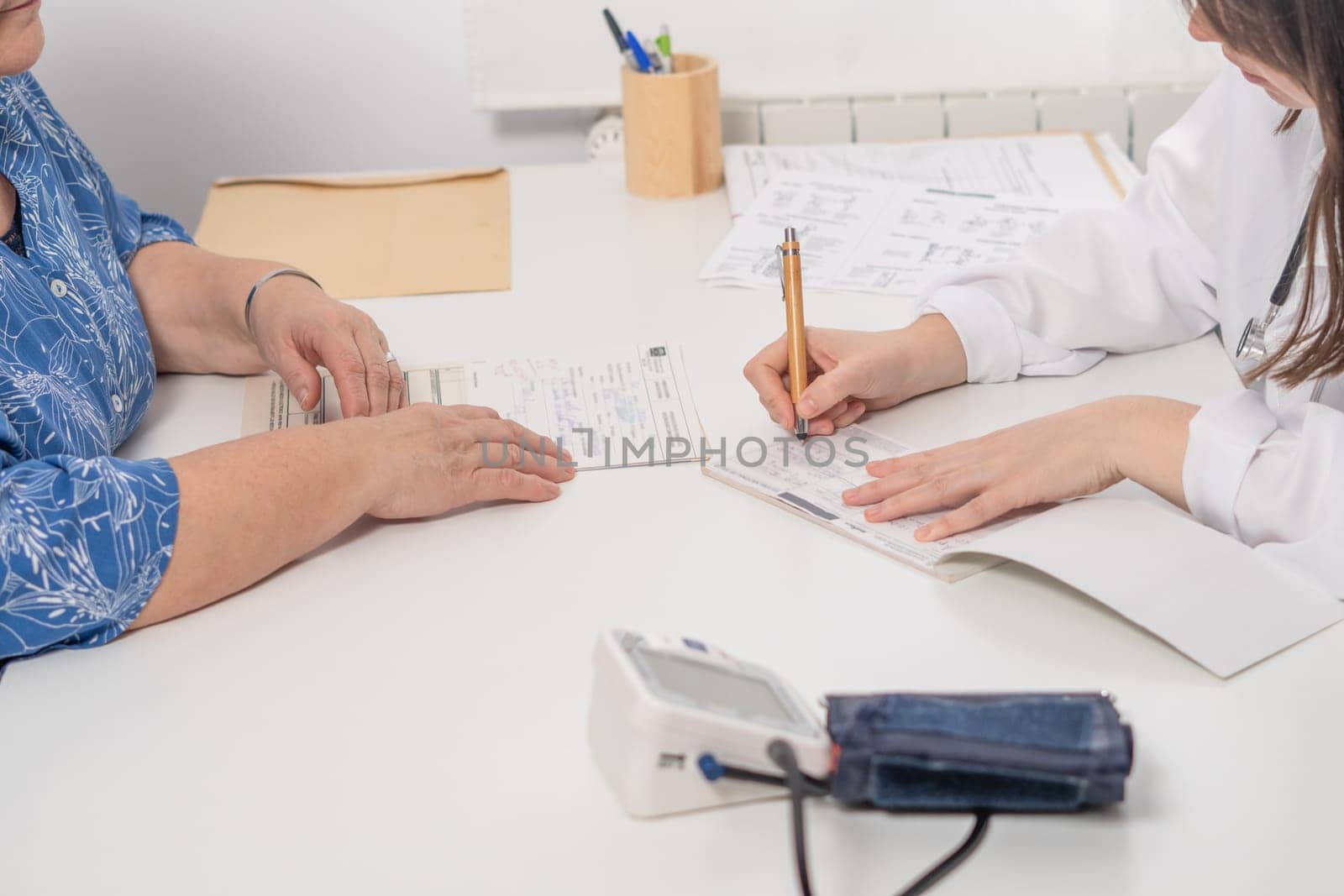 woman doctor writing a prescription to her patient at the doctor's office