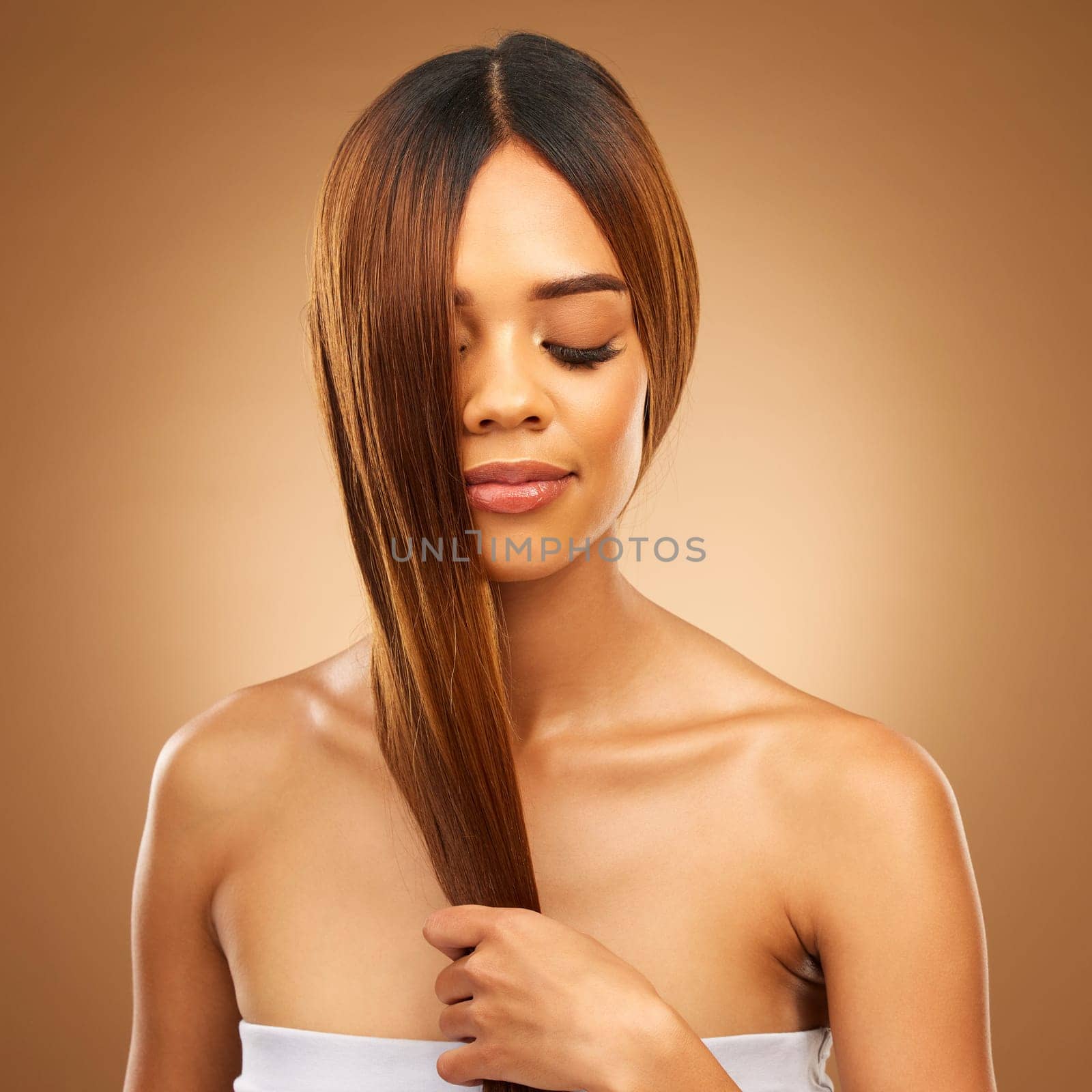 Haircare, studio and woman with hair in hand, strong with bronze texture and salon shine. Wellness model, mockup and spa beauty, healthy straight hairstyle with keratin product on brown background