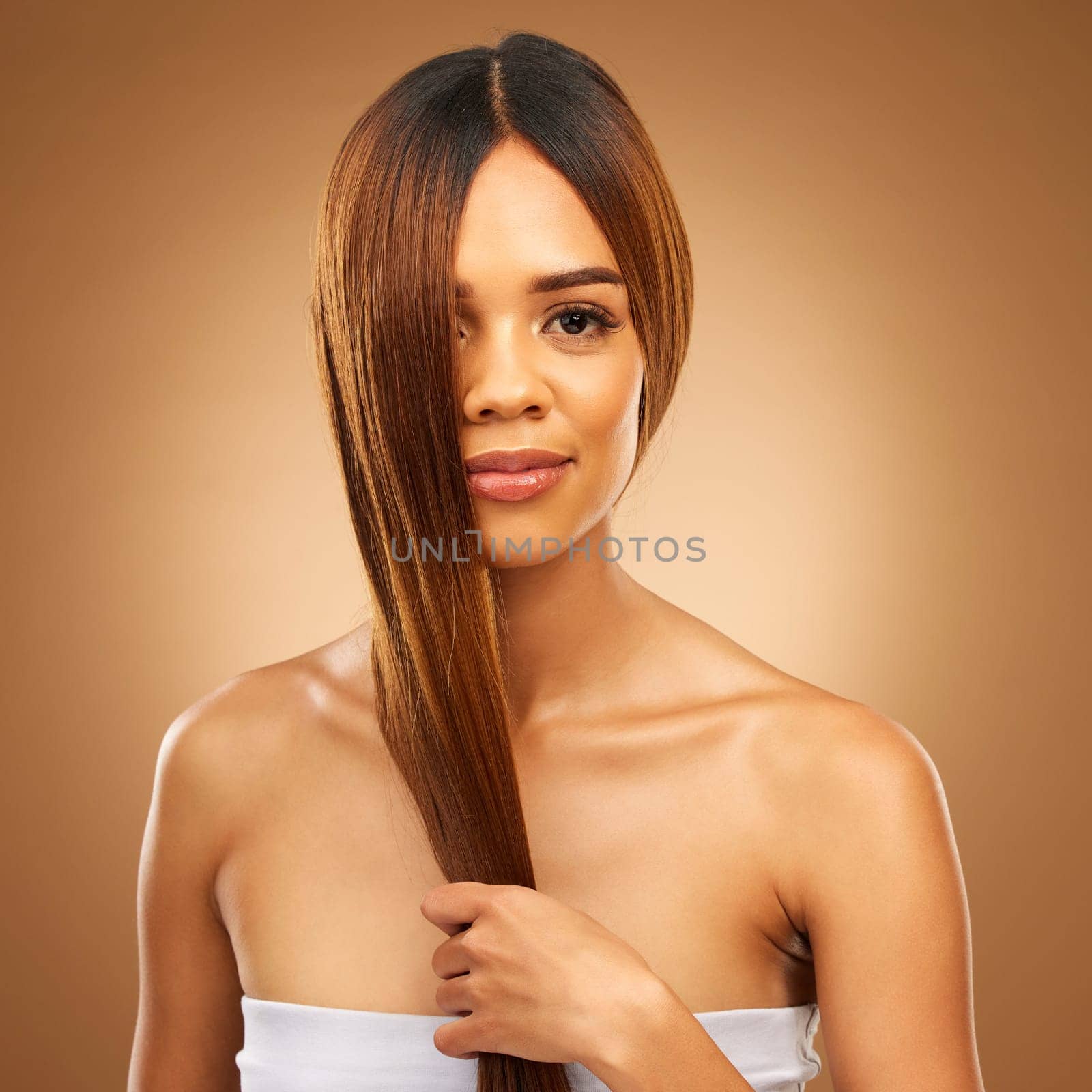 Haircare, studio and portrait of woman holding strong hair in hand with texture and salon shine. Skincare model, mockup and beauty, healthy straight hairstyle with keratin product on brown background.