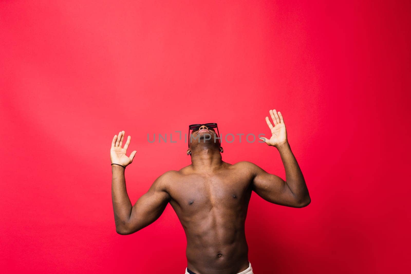 Like what you see. A handsome and muscular young man posing in a studio.