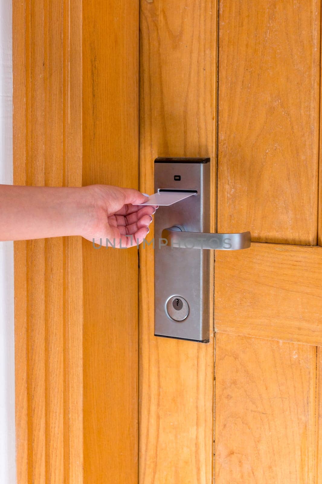 Close up of female hand hold key card and open electronic lock door.