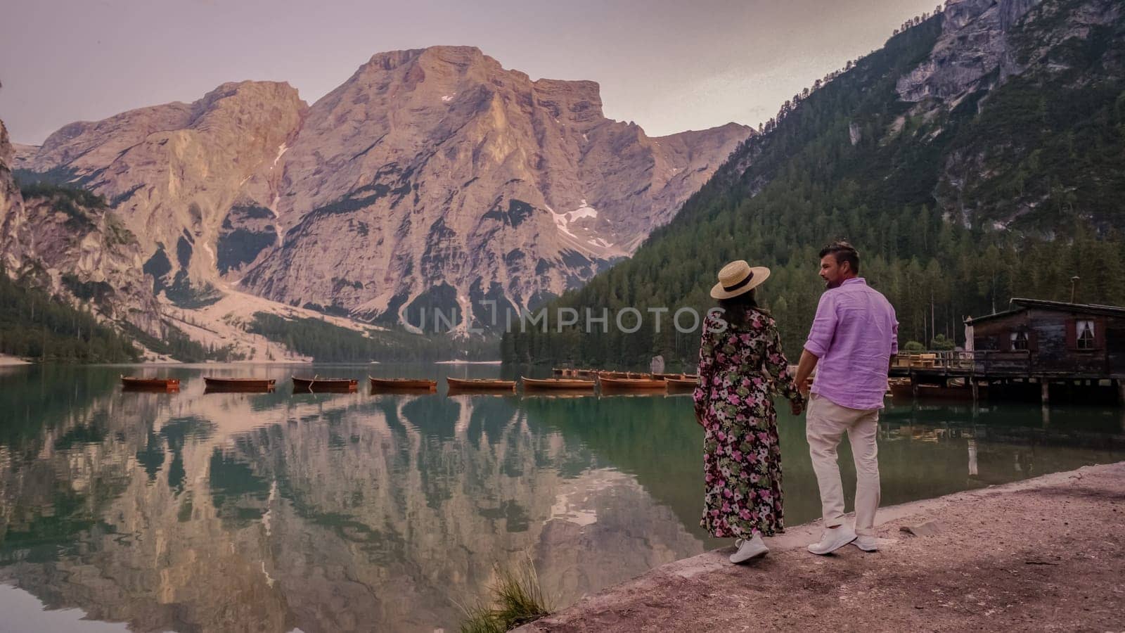 Couple men and women at Lago Di Braies lake mountains Italy, Pragser Wildsee South Tyrol Dolomites by fokkebok