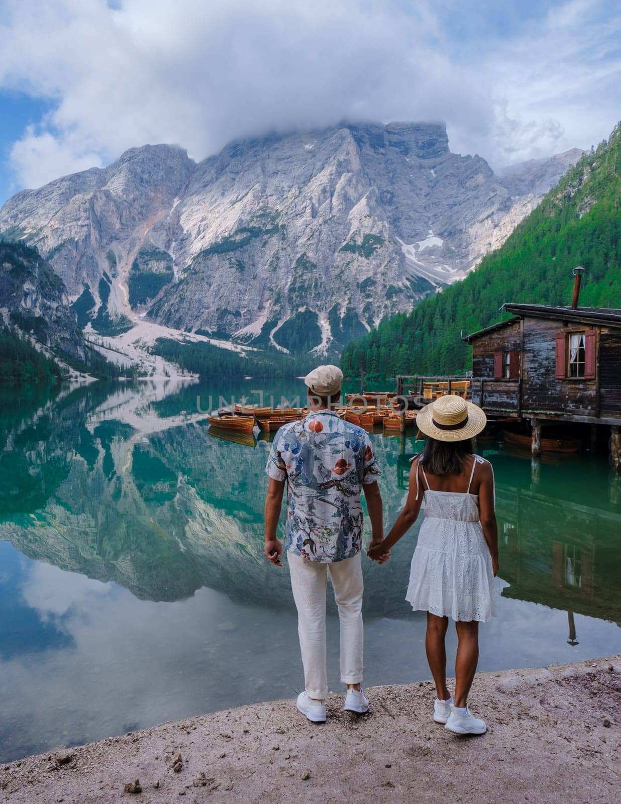 Couple men and women at Lago Di Braies lake mountains Italy, Pragser Wildsee South Tyrol Dolomites by fokkebok