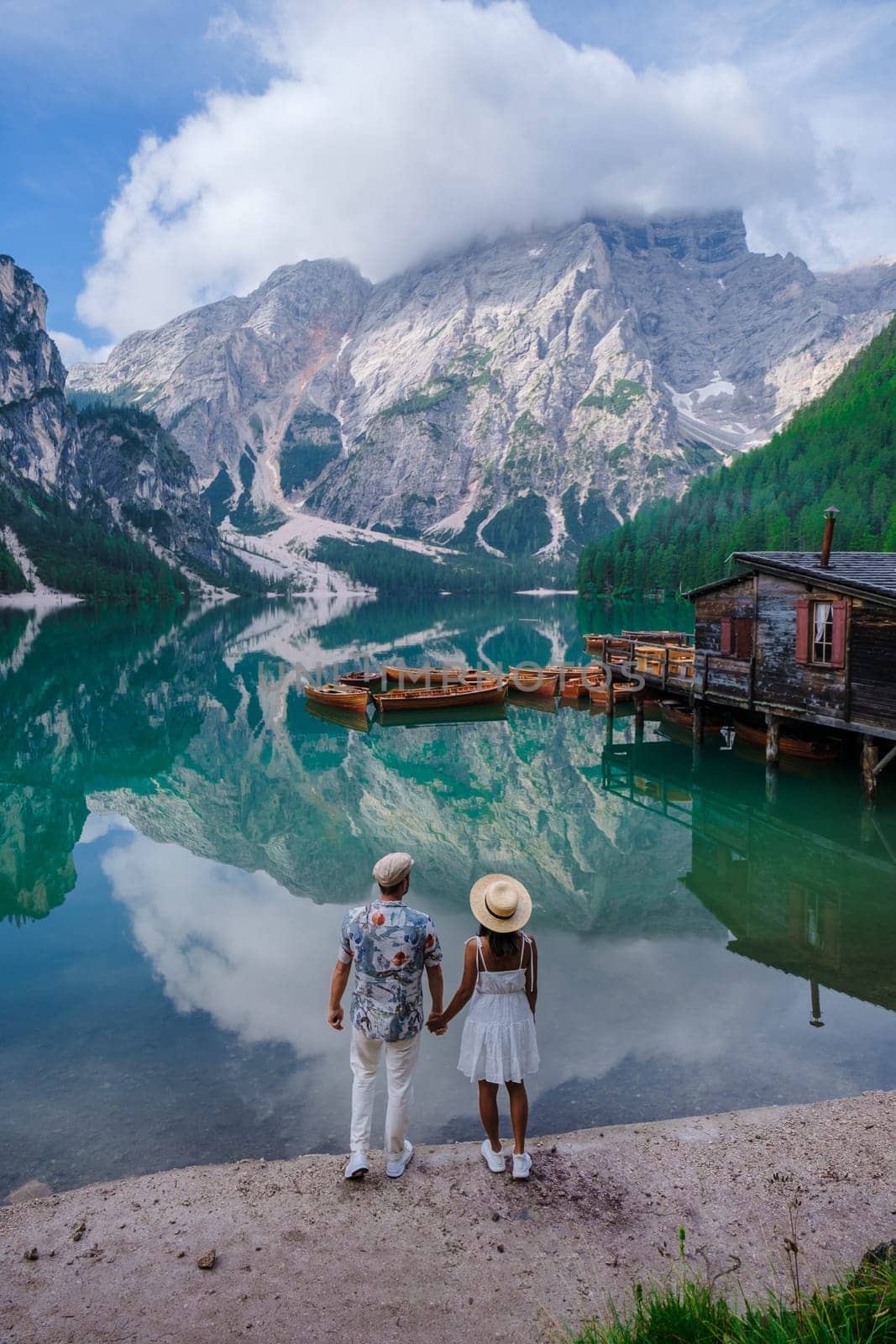 Couple men and women at Lago Di Braies lake mountains Italy, Pragser Wildsee South Tyrol Dolomites by fokkebok