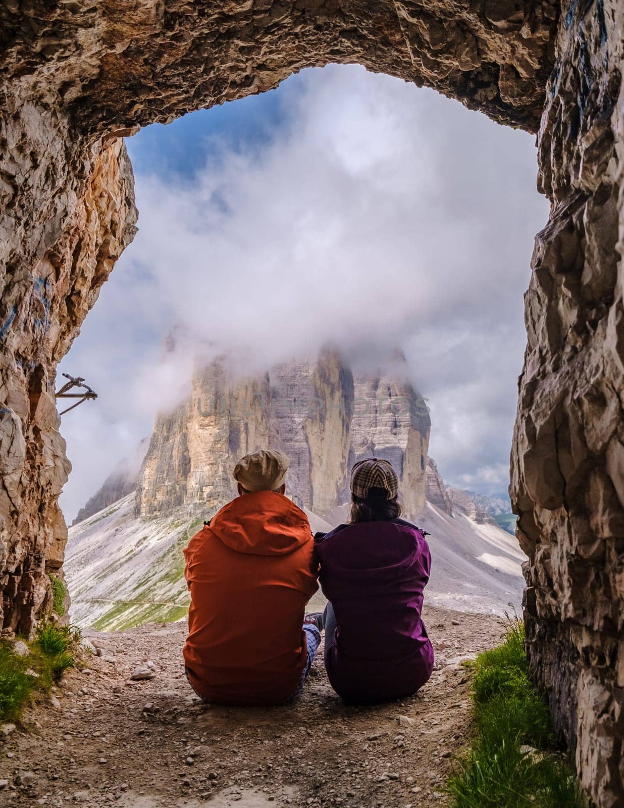 Tre Cime di Lavaredo peaks or Drei Zinnen at sunset, Dobbiaco Toblach, Trentino -Alto Adige, or South Tyrol, Italy. Europe Alps. A couple of men and woman hiking in the Dolomites