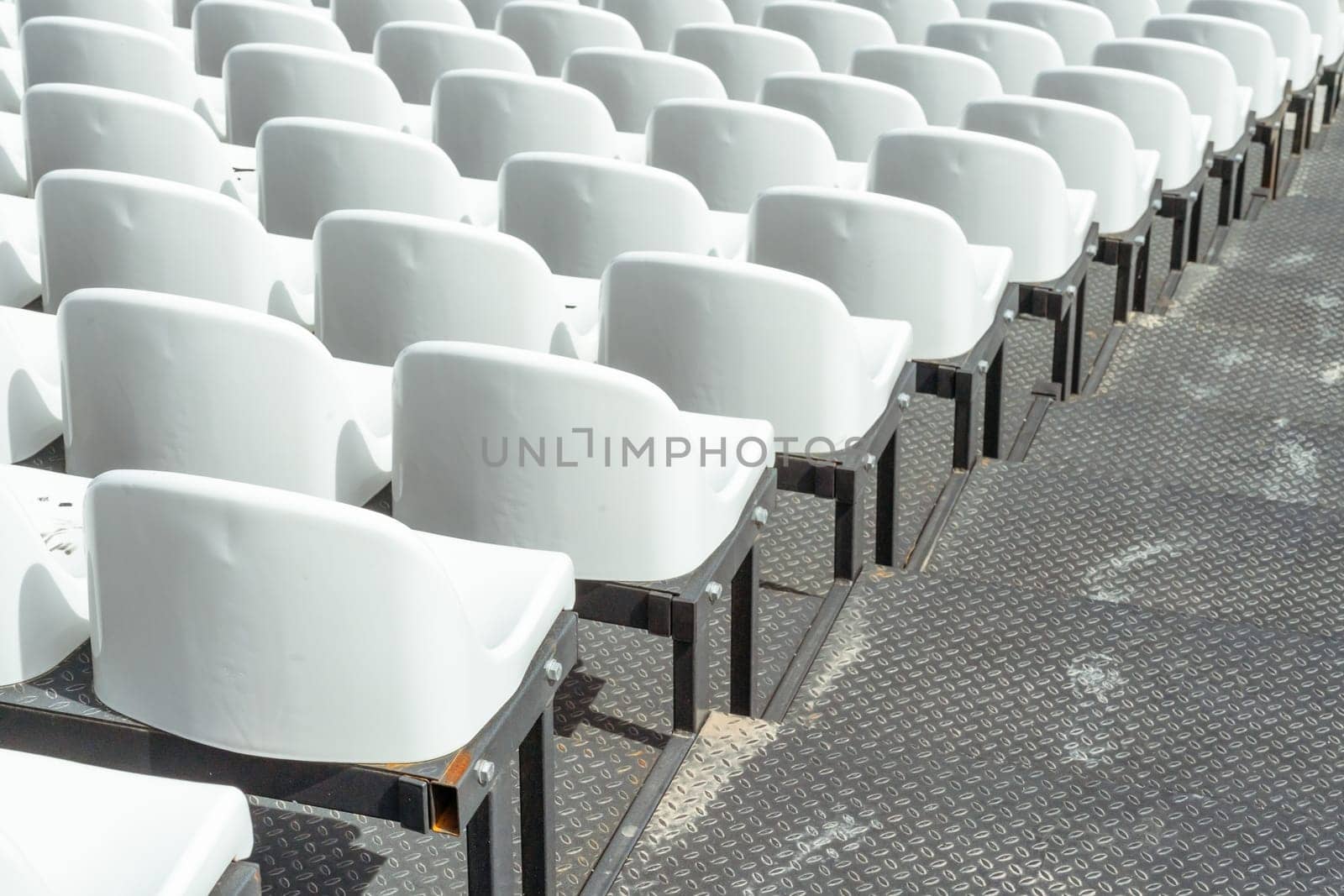 Seats of tribune on sport stadium. Concept of fans, chairs for audience, cultural environment concept. mpty seats, modern stadium. by Matiunina