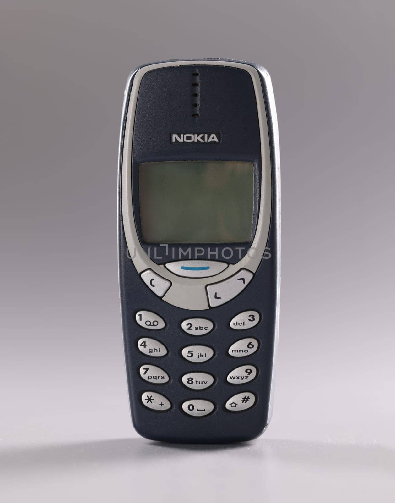 Georgia Tbilisi August 22, 2022: Original Nokia 3310 in blue case on gray background. Legendary nokia 3310 concept