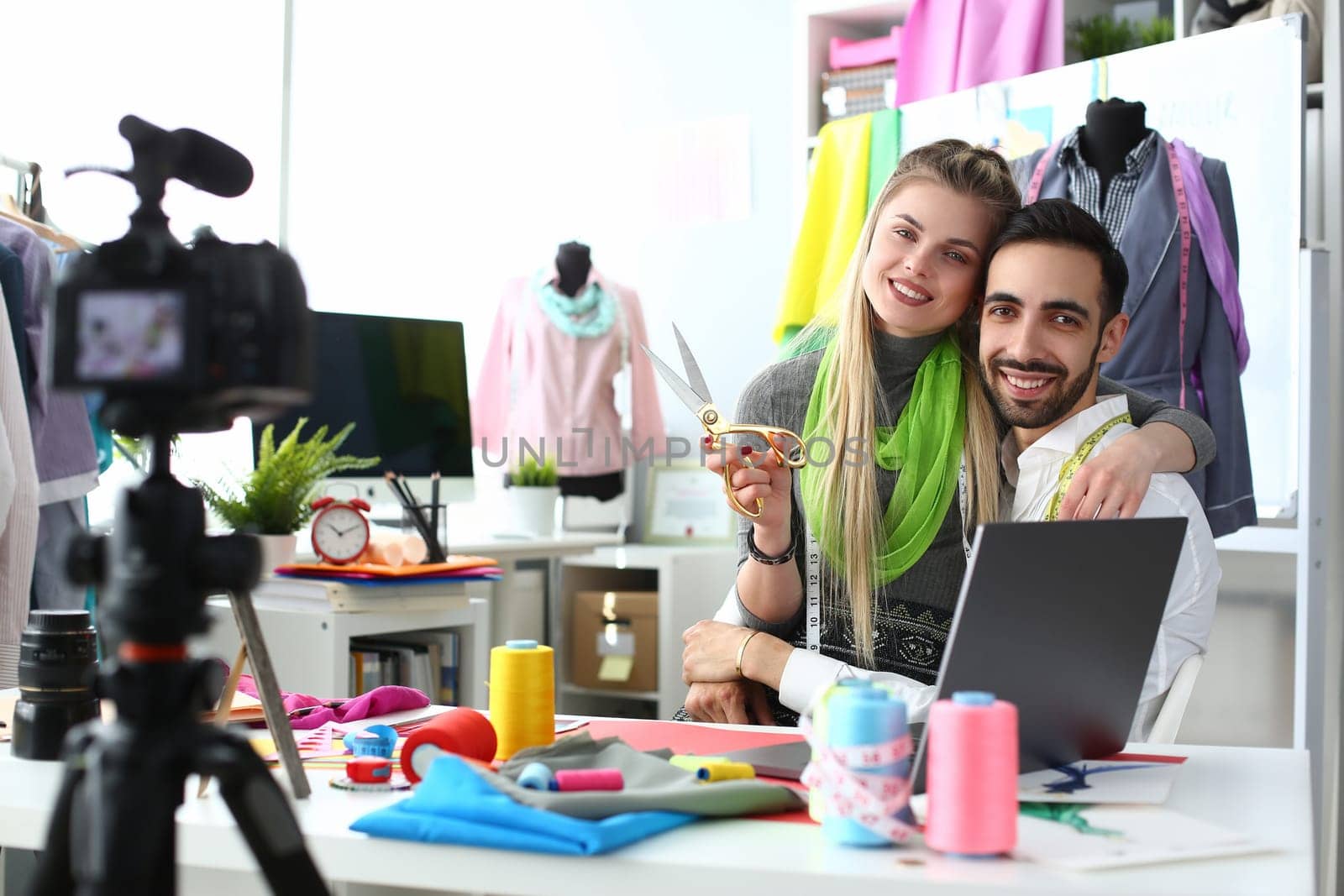 Happy smiling man and woman fashion designer stylists at workplace in atelier by kuprevich