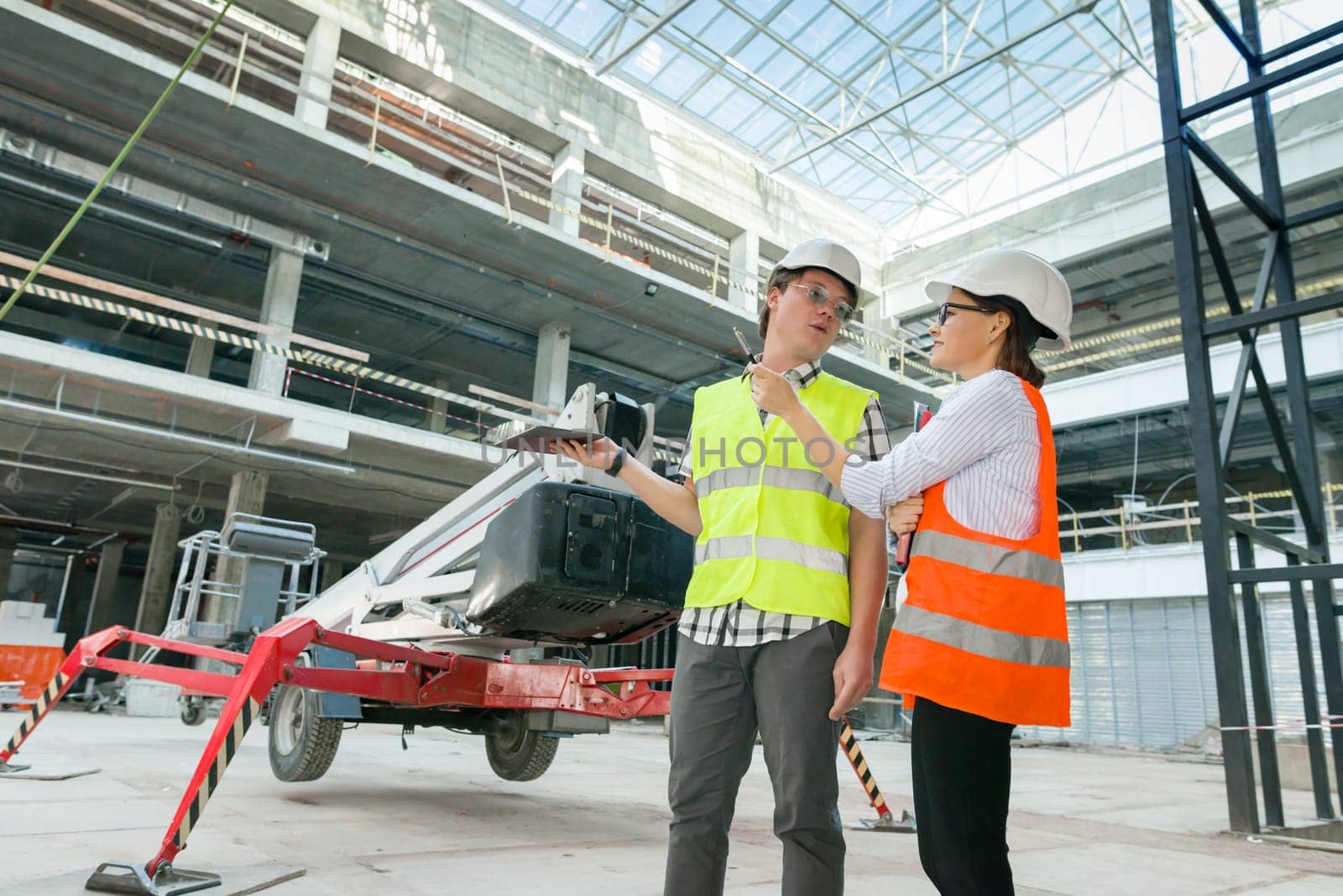 Industrial portrait of male and female engineers in construction of commercial administrative building