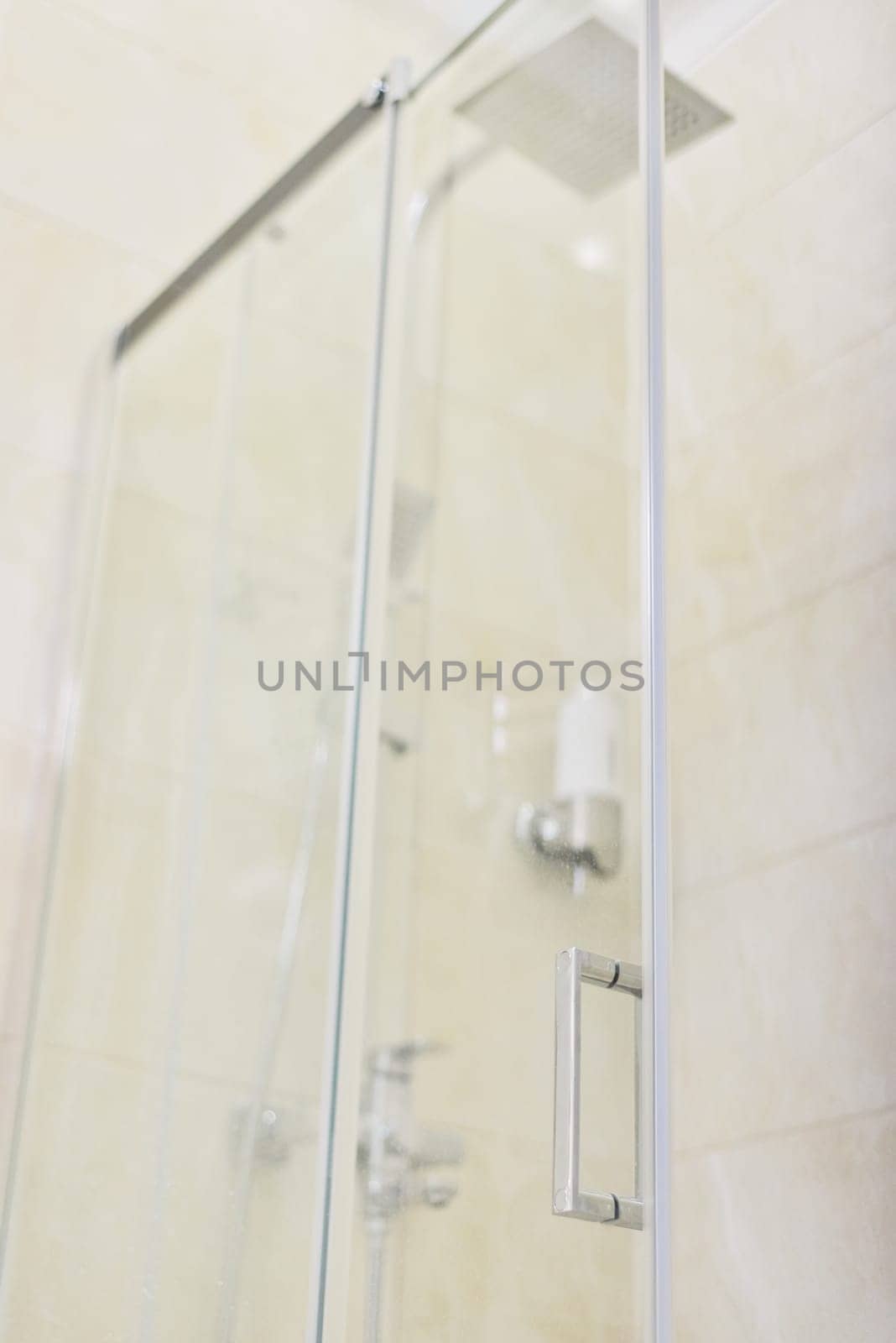 Shower, bathroom interior, light beige color, glass door with chrome handle close-up