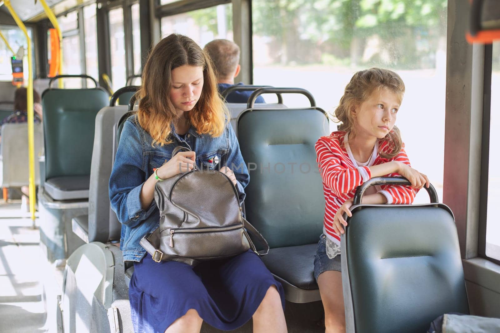 Passengers of a city bus, trolleybus sitting on the seats