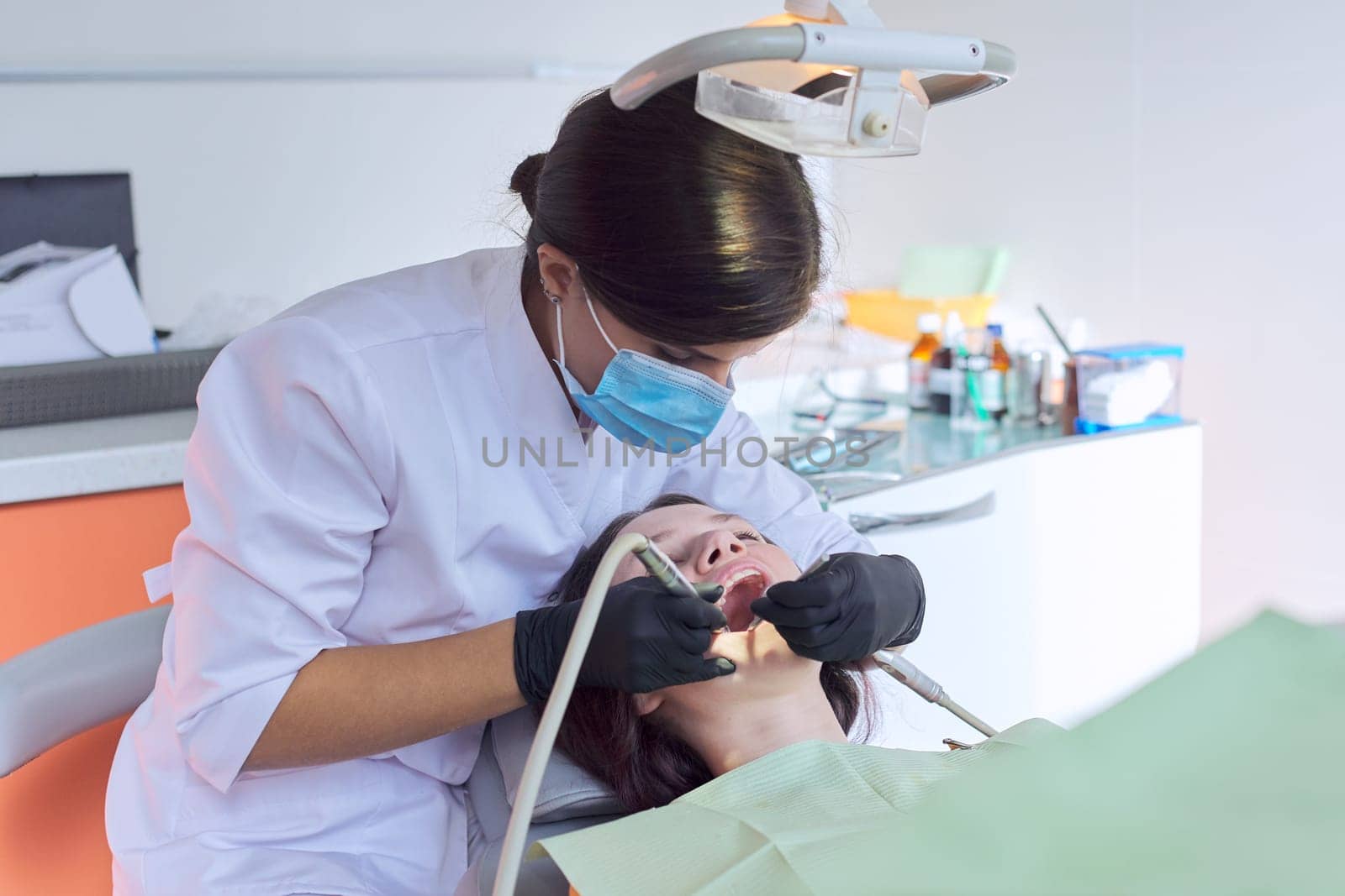 Teenager girl treating teeth at dentist office, consultation of orthodontist by VH-studio