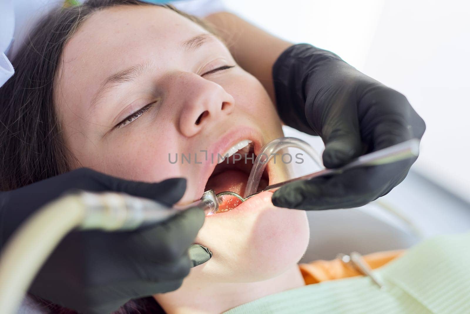 Close up dental treatment procedure in dental office by VH-studio