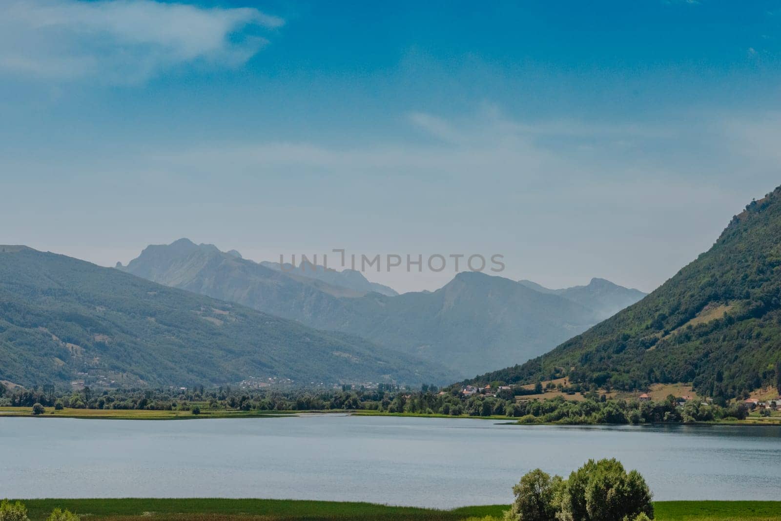 Montenegro. Kotor Bay. A picturesque view from the water to the coastal town of Dobrota. Kotor bay in a beautiful summer day, Montenegro by Andrii_Ko