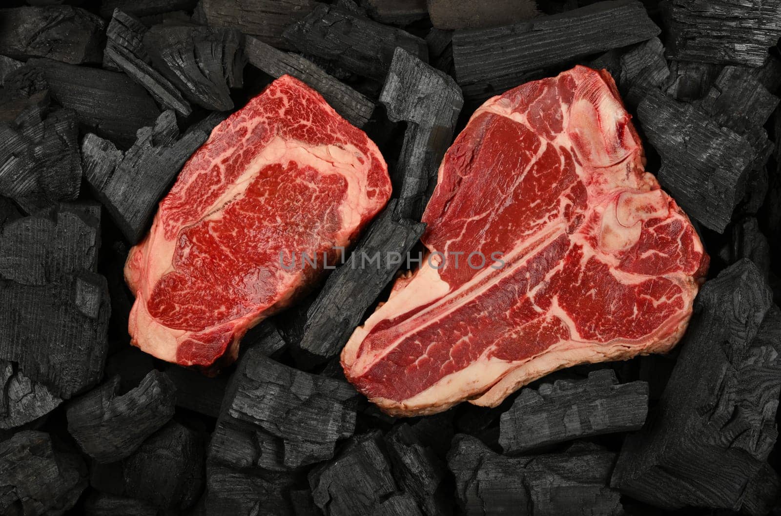 Cooking raw beef steaks on charcoal by BreakingTheWalls