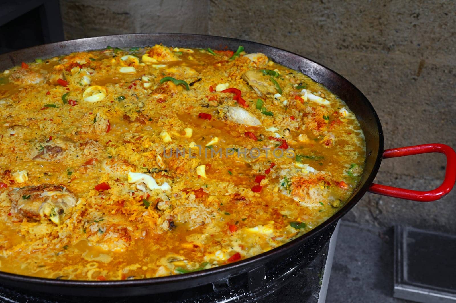 Close up cooking Spanish paella in big frying pan by BreakingTheWalls