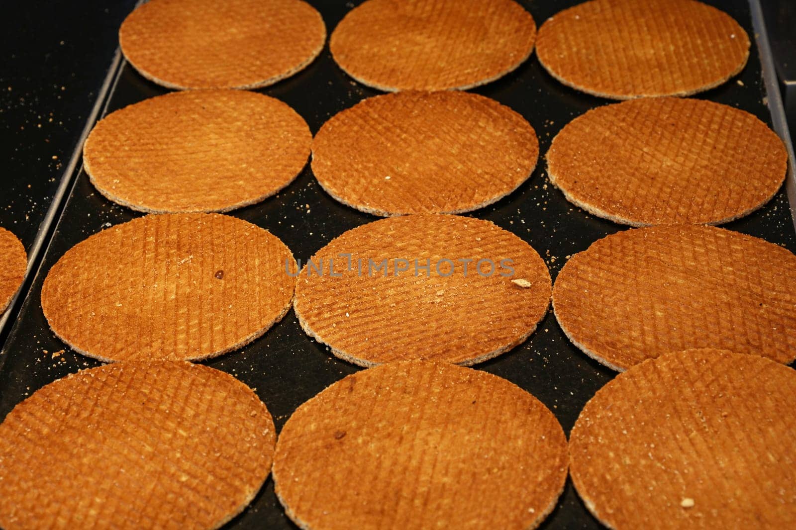 Dutch stroopwafel waffles cookies on baking pan by BreakingTheWalls