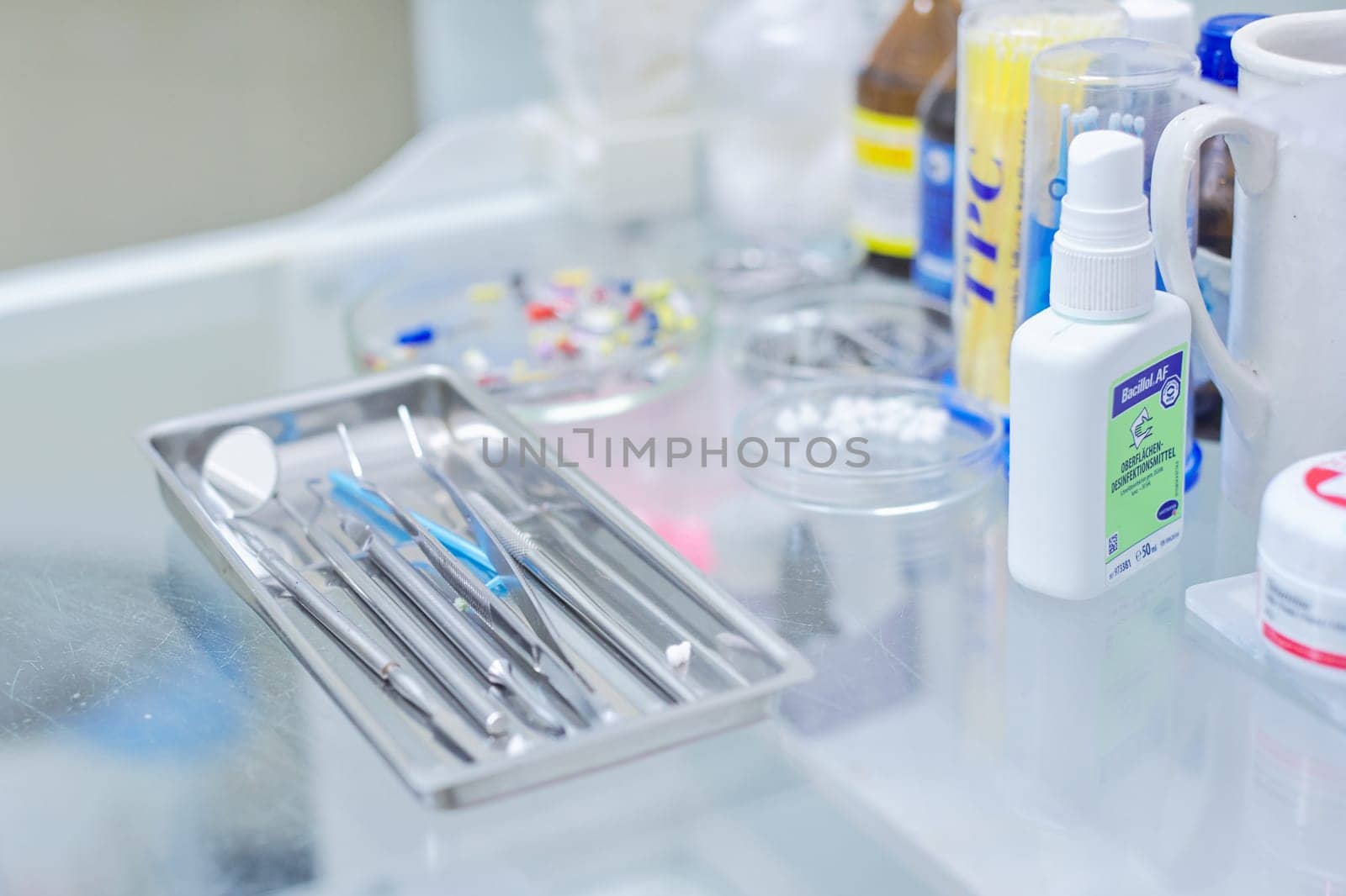 Kyiv UA, 31-07-2019. Close-up of working desk in dentist office with dental composite sealing materials resins, various professional dental instruments tools and medicines