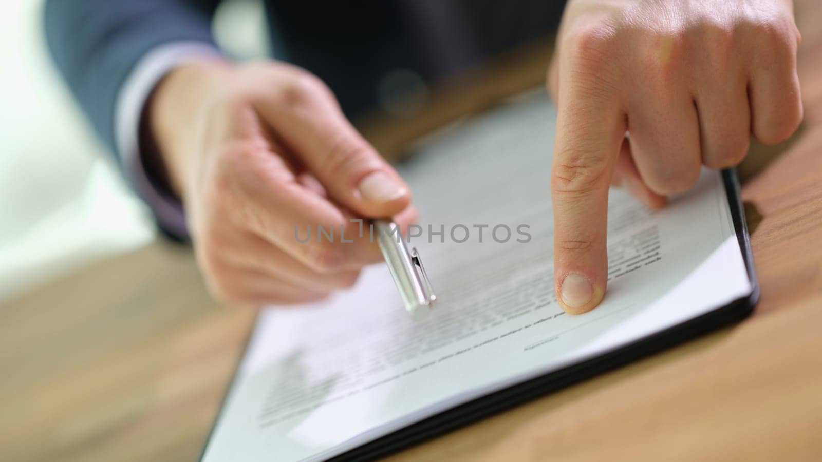 Manager showing client place to sign in document and holding out pen closeup. Legal work with clients and sale of real estate concept
