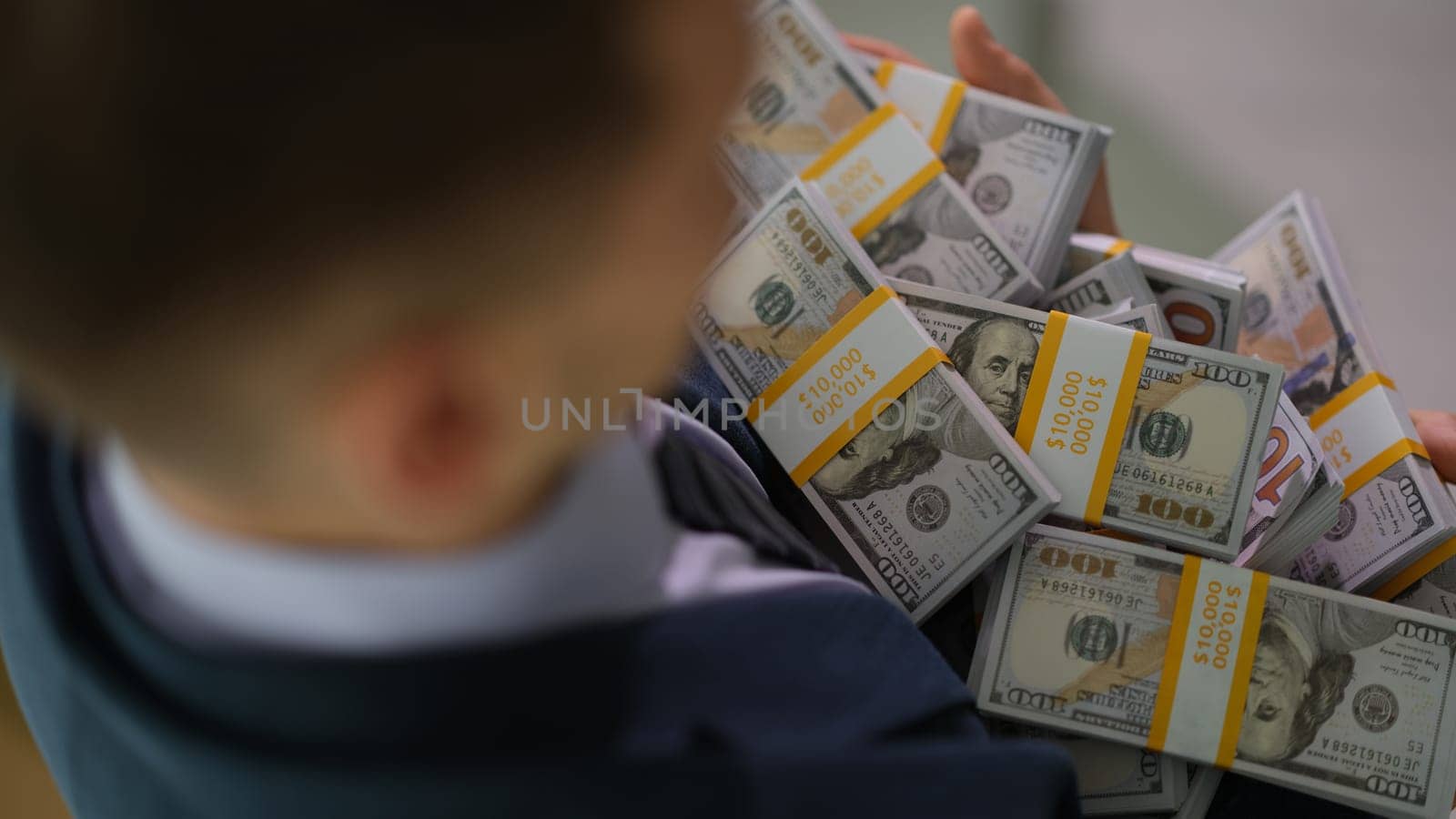 Banker holding in hands lot of packages with money closeup. Lottery win and business success concept