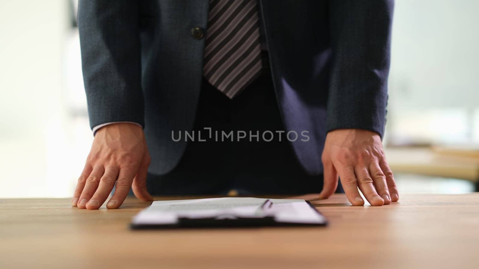 Manager standing at table with documents at business conference closeup by kuprevich
