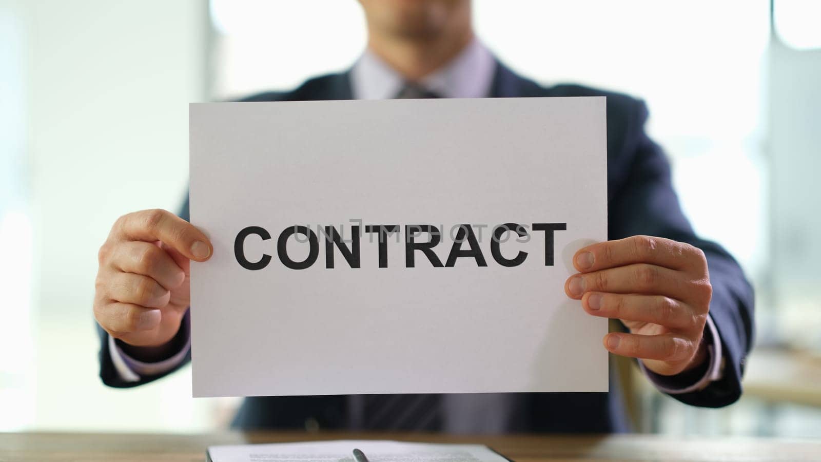 Hands of businessman holding contract document for employment at work in office closeup. Legal job placement concept