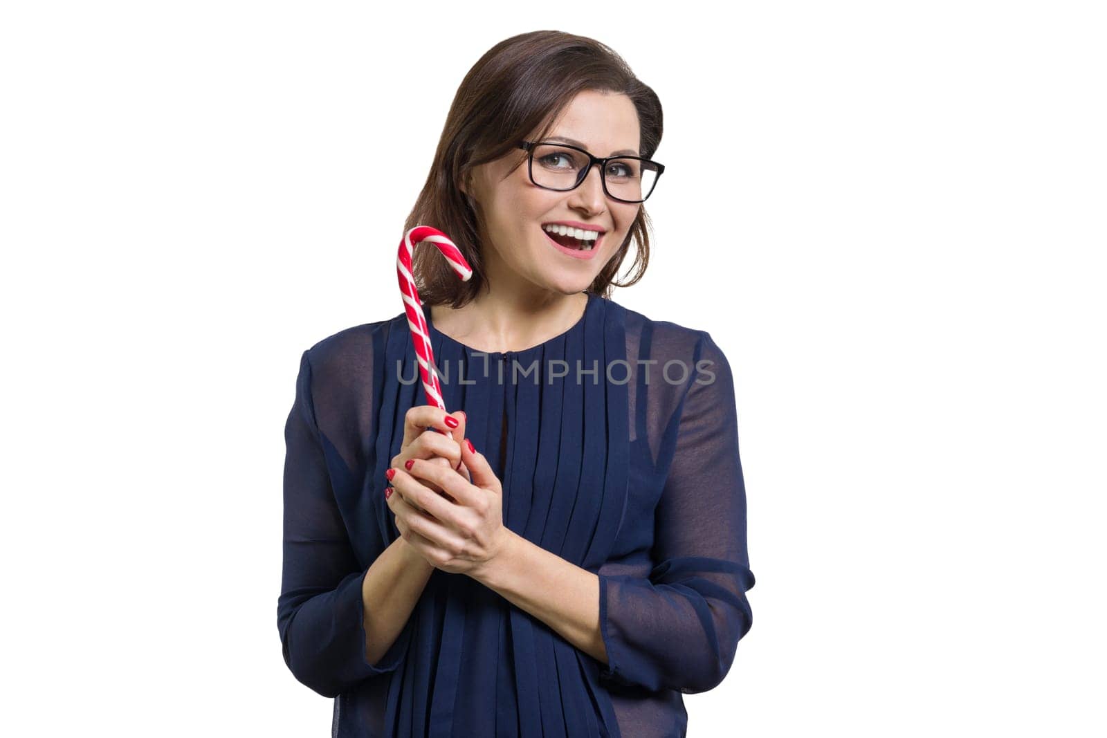 Mature happy woman with candies canes christmas candy isolated on white background.