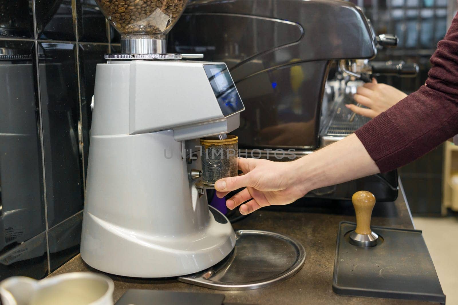 Closeup of coffee making process, hands of barista using a coffee machine.