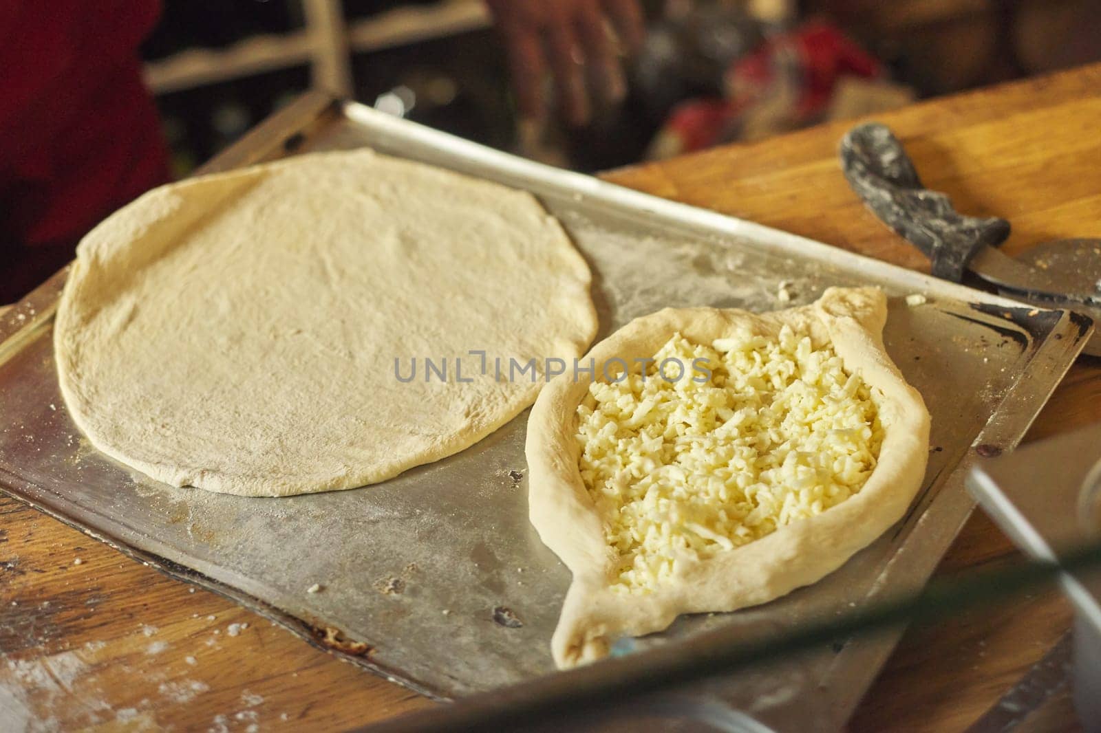 Healthy natural food, hands of man preparing khachapuri, on the table flour dough cheese. Cooking process, culinary, recipe, home bakery.