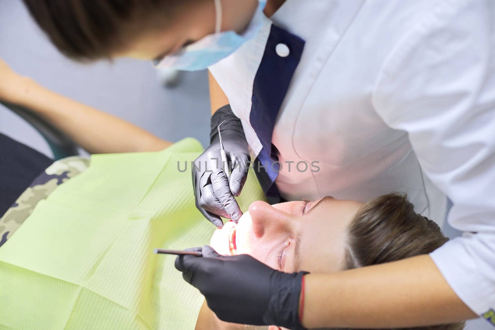 Close up dental treatment procedure in dental office by VH-studio