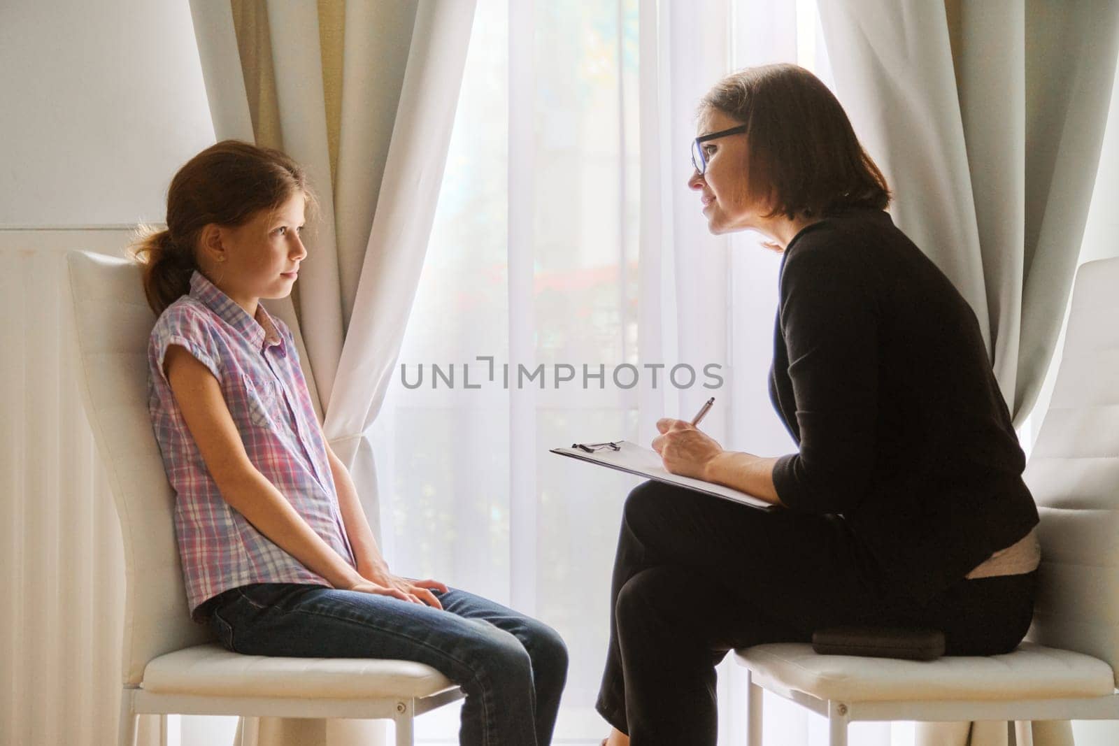 Teacher teaching and talking to a girl child, private individual lesson by VH-studio