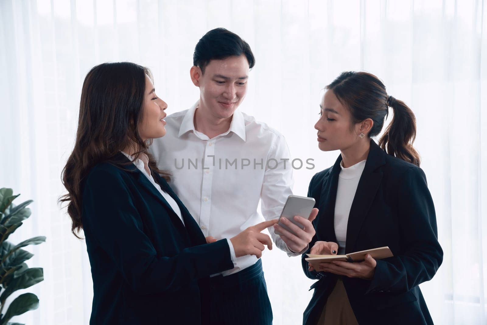 Mentor, manager advice younger colleagues in workplace. Businesspeople discussing or planning financial project strategy, talking together for harmony and strong teamwork in office concept.