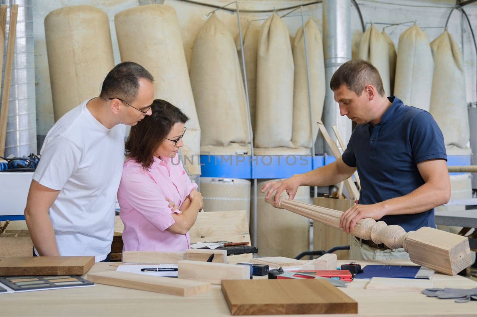 Industrial woodworking workshop, team of people discussing carpentry process by VH-studio